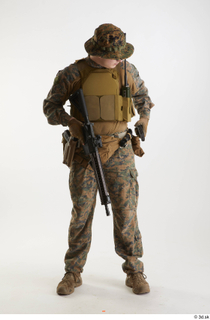 Casey Schneider in WDL Marpat Pose 5 loading gun standing…